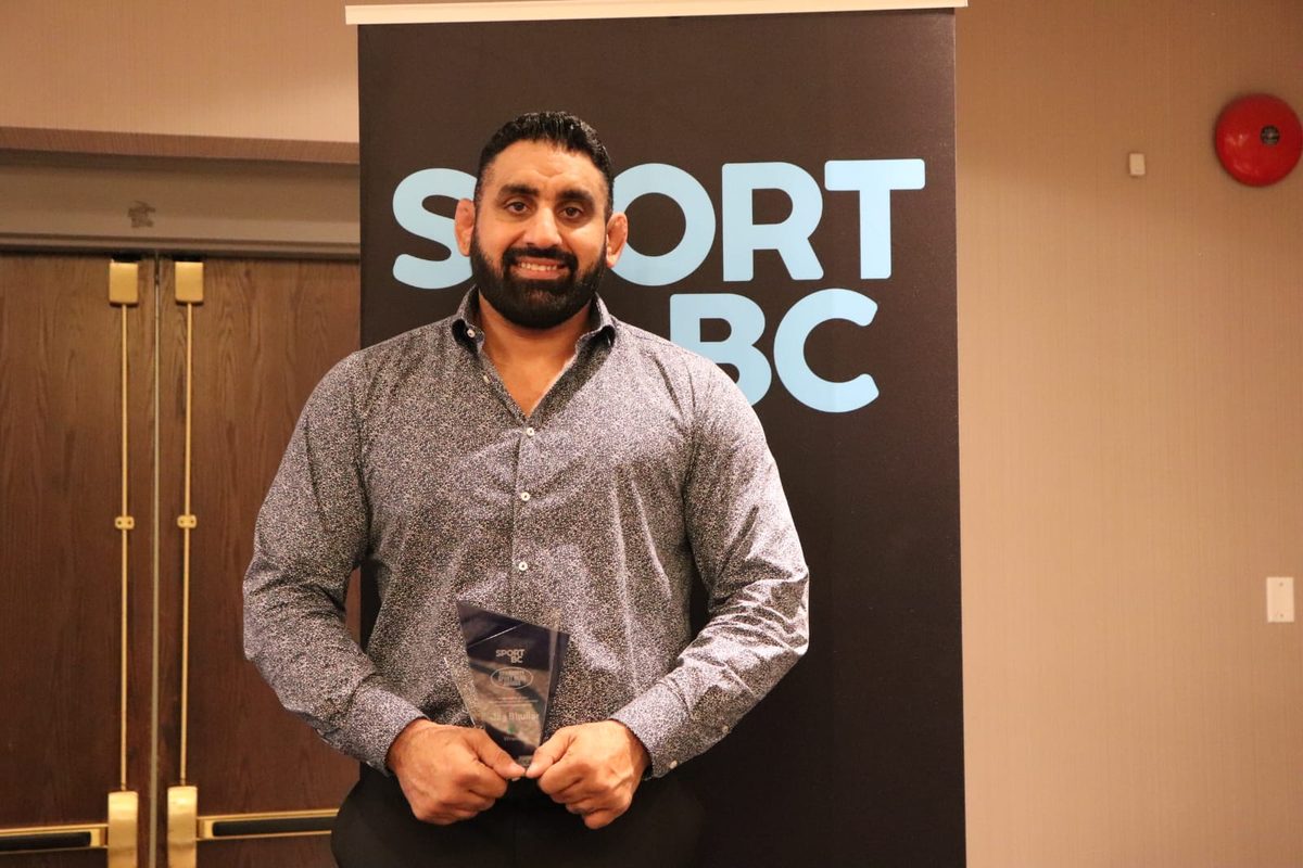 Coach Jag with Sport BC Sport Hero trophy